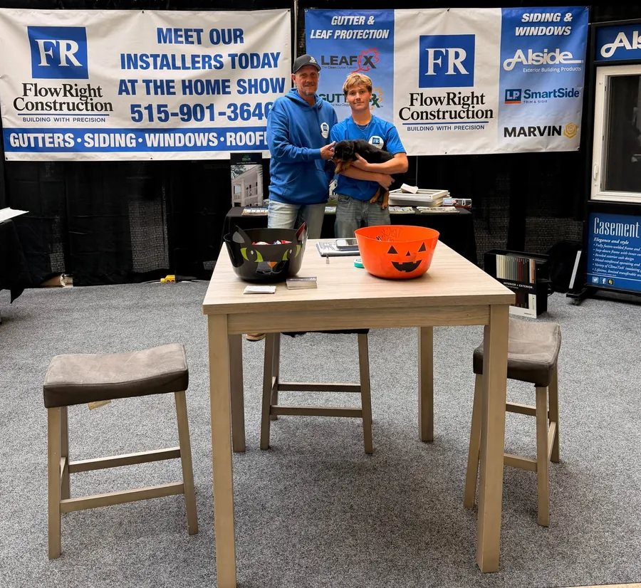 The Flow Right Construction booth at the Iowa Home Expo with gutter, siding and window banners