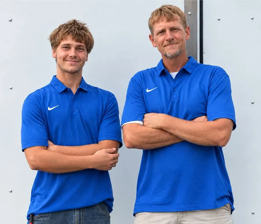 Luke and Jaxx of Flow Right Construction in matching blue company shirts