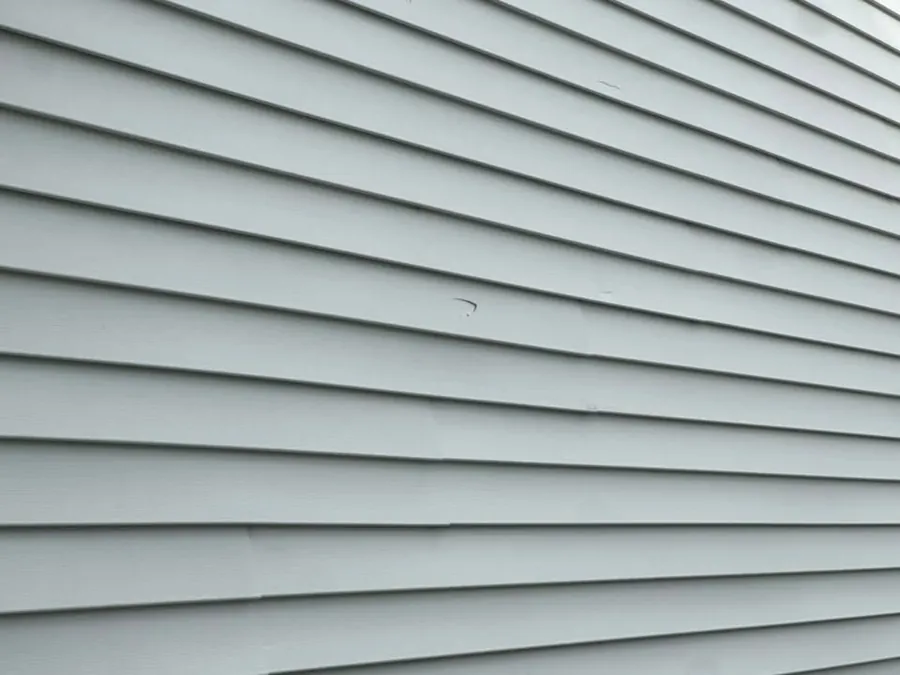 Detail of light gray lap siding courses